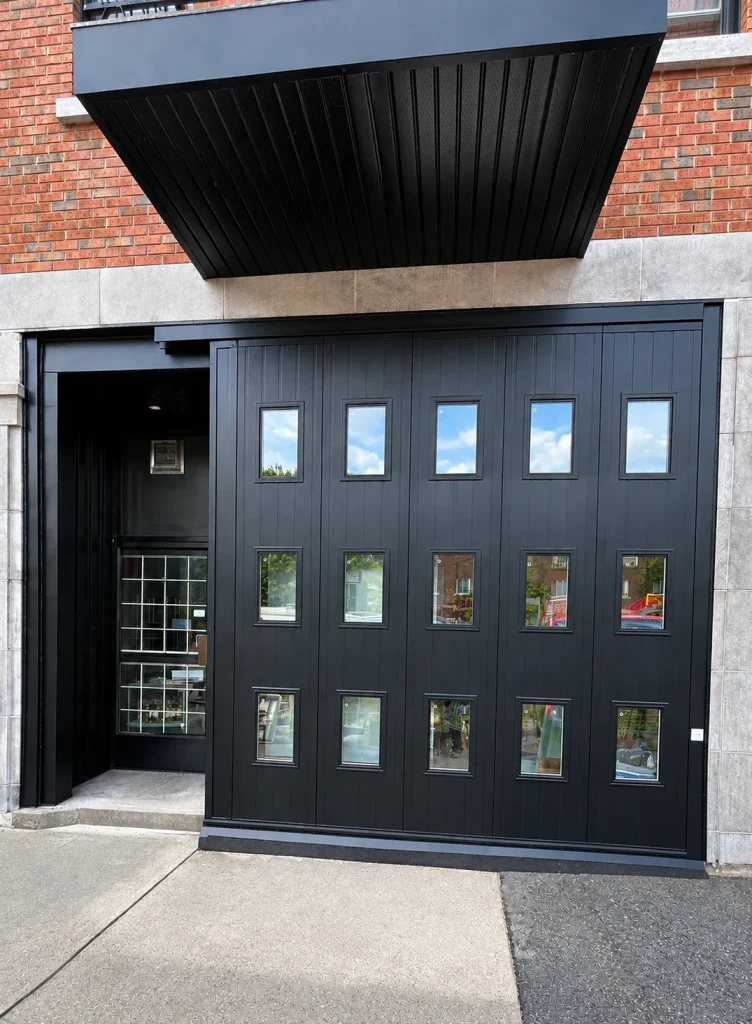 Commercial storefront with black folding doors and canopy, built by ZEM RENO